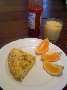Spanish Frittata with orange slices, juice and hot sauce