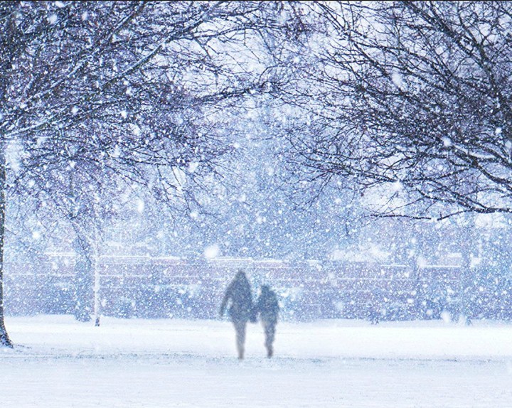 Woman and boy walking in snow