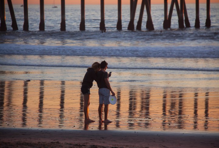 Couple taking pictures at Venice Beach