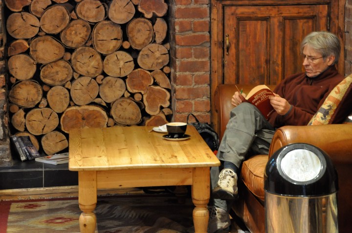 Man reading at coffee shop in Cardiff