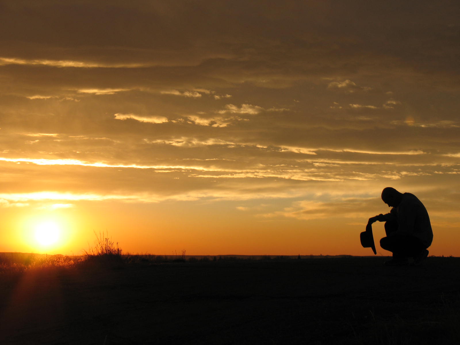 Cowboy praying at dawn