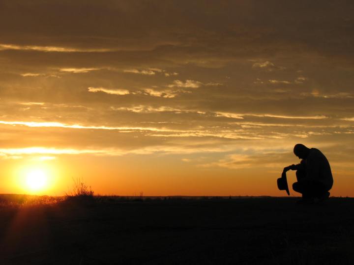 Cowboy praying at dawn