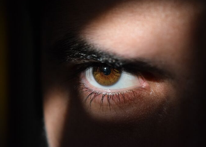 Man's eye in shadow