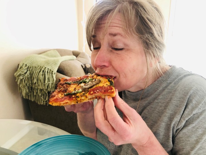 Heather enjoying pizza