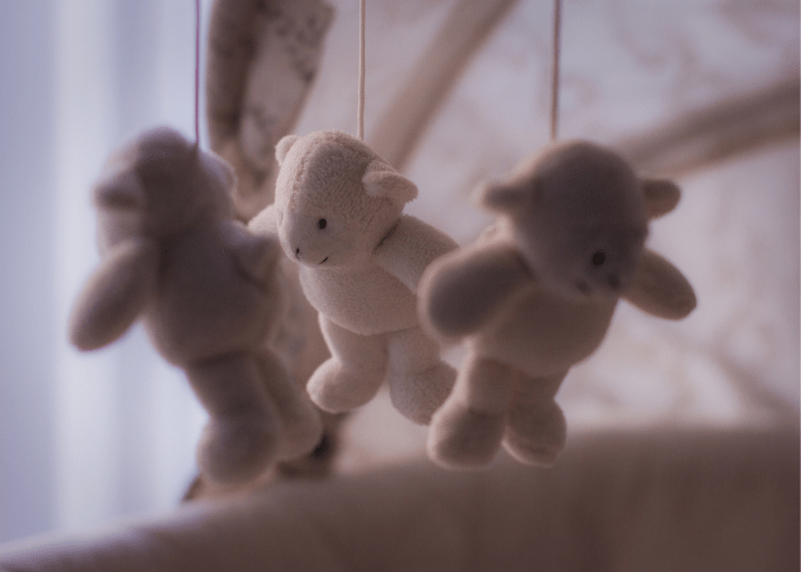 Teddy bear mobile above a crib