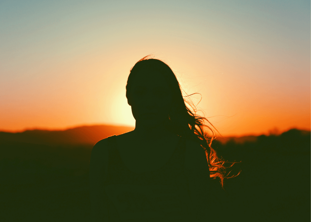 Silhouette of a woman at sunset