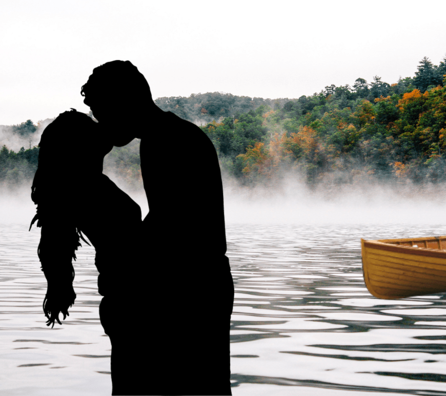 Couple kissing in front of lake