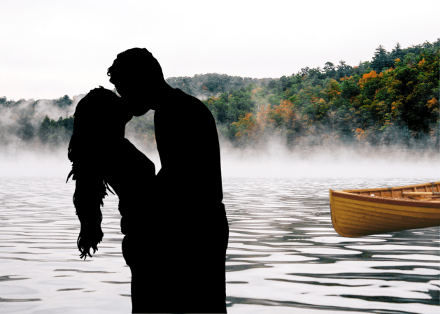 Couple kissing in front of lake