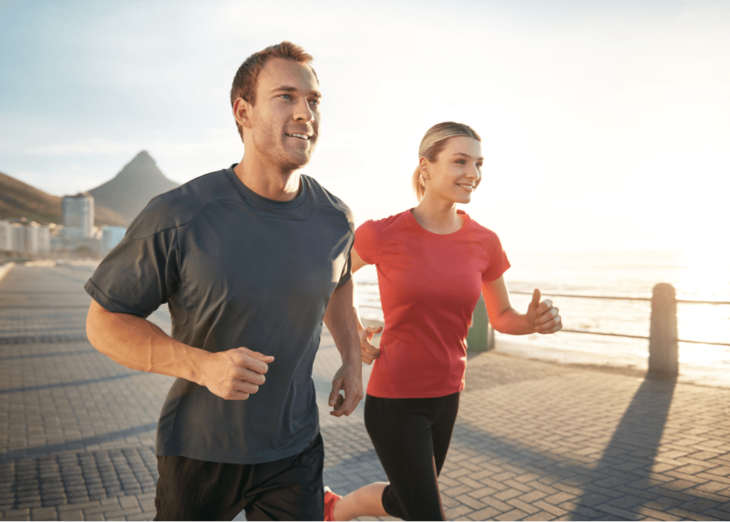 Couple running by beach