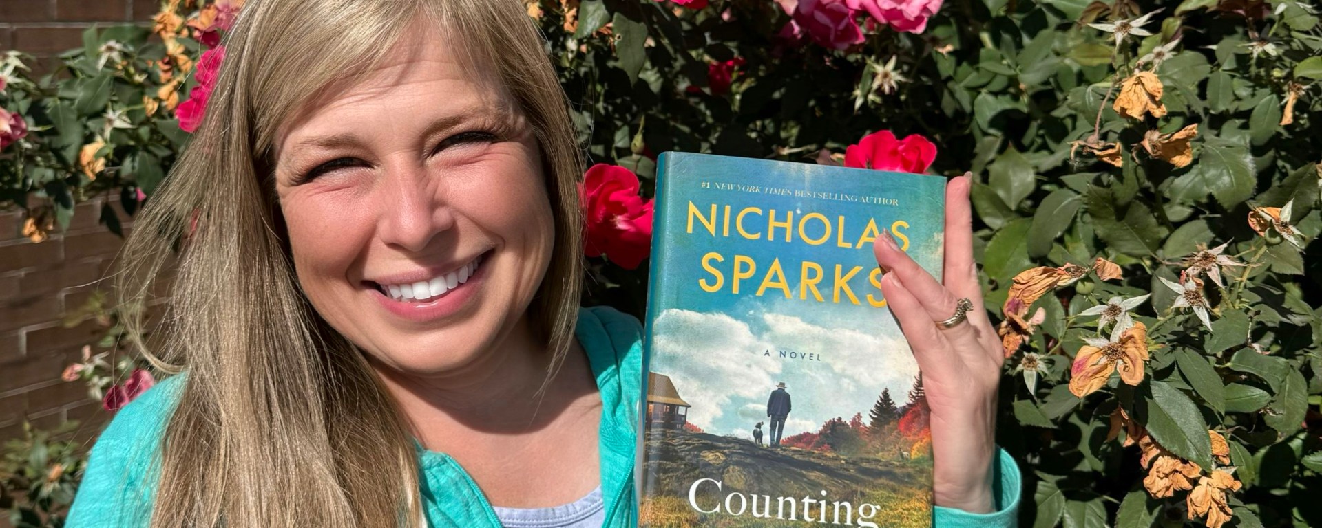 Heather Fink holds copy of Nicholas Sparks' Counting Miracles